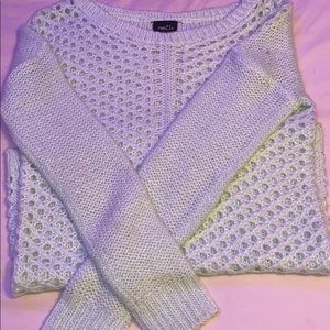 A women’s light blue sweater